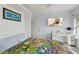 Cozy bedroom features a comfortable bed with colorful quilt, a wall-mounted TV, and a functional desk area at 3425 S Atlantic Ave # 1206, Daytona Beach Shores, FL 32118