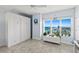 Bedroom featuring a Murphy bed, large window with ocean view, and tile flooring at 3425 S Atlantic Ave # 1206, Daytona Beach Shores, FL 32118