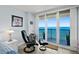 Bedroom with sitting area and sliding glass doors to balcony with an ocean view at 3425 S Atlantic Ave # 1206, Daytona Beach Shores, FL 32118