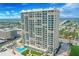 Stunning high-rise condo building with a pool and beautiful landscaping, offering panoramic views of the ocean and city at 3425 S Atlantic Ave # 1206, Daytona Beach Shores, FL 32118