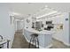Open-concept kitchen featuring marble countertops, stainless appliances, and a breakfast bar with a stool at 3425 S Atlantic Ave # 1206, Daytona Beach Shores, FL 32118
