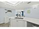 Open kitchen with a marble countertop, modern sink, and a view into the well-lit living area at 3425 S Atlantic Ave # 1206, Daytona Beach Shores, FL 32118