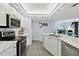 Modern kitchen with white cabinets, marble countertops, stainless steel appliances, and open floor plan at 3425 S Atlantic Ave # 1206, Daytona Beach Shores, FL 32118