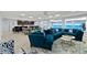 Relax in this spacious living room, featuring a large sectional couch with views of the ocean at 3425 S Atlantic Ave # 1206, Daytona Beach Shores, FL 32118