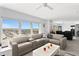Open-concept living room with comfortable seating and expansive windows that fill the space with natural light at 3425 S Atlantic Ave # 1206, Daytona Beach Shores, FL 32118