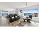 Spacious and bright living room with comfortable seating and beautiful ocean views through large windows at 3425 S Atlantic Ave # 1206, Daytona Beach Shores, FL 32118