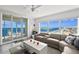 Bright living room featuring a modern couch, a white coffee table, and floor-to-ceiling windows with ocean views at 3425 S Atlantic Ave # 1206, Daytona Beach Shores, FL 32118