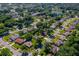 Scenic aerial view of a neighborhood featuring tree-lined streets and a community pond at 3441 Country Walk Dr, Port Orange, FL 32129