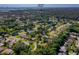 Aerial view of a lush neighborhood with trees near Sugar Mill Elementary and the ocean at 3441 Country Walk Dr, Port Orange, FL 32129