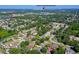 High aerial shows neighborhood homes and the Daytona International Speedway on the horizon at 3441 Country Walk Dr, Port Orange, FL 32129