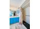 Bright bathroom featuring blue vanity and a walk-in shower with palm-themed curtain at 3441 Country Walk Dr, Port Orange, FL 32129