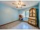 This bedroom features light blue walls, a ceiling fan, a tile floor and an antique dresser at 3441 Country Walk Dr, Port Orange, FL 32129