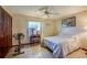 This sunny bedroom includes a ceiling fan, neutral paint, an exercise bike, and a built-in vanity at 3441 Country Walk Dr, Port Orange, FL 32129