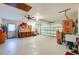 Large garage with room for storage, work area, utility sink, and a roll-up door at 3441 Country Walk Dr, Port Orange, FL 32129