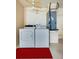 Functional laundry area with washer, dryer, utility equipment and bright red accent rug at 3441 Country Walk Dr, Port Orange, FL 32129