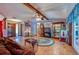 Comfortable living room with tile floors, exposed beam ceiling, and a decorative area rug at 3441 Country Walk Dr, Port Orange, FL 32129