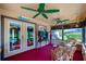 Enclosed sunroom with wicker furniture, television, and views of the backyard at 3441 Country Walk Dr, Port Orange, FL 32129
