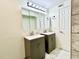 Modern bathroom with double vanities, stylish lighting, and tiled accents at 370 S Center St, Ormond Beach, FL 32174