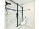 Contemporary bathroom featuring a walk-in shower with sleek glass door and tiled walls at 370 S Center St, Ormond Beach, FL 32174