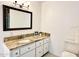 Clean bathroom featuring a granite countertop vanity, white cabinets, and a neutral color scheme at 370 S Center St, Ormond Beach, FL 32174