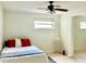 Well-lit bedroom featuring dual windows, a ceiling fan, and neutral decor at 370 S Center St, Ormond Beach, FL 32174
