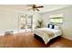 Bright bedroom featuring wood floors, a ceiling fan, and glass doors at 370 S Center St, Ormond Beach, FL 32174