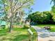 Community garden with informative signage and adjacent bench seating near sidewalk at 370 S Center St, Ormond Beach, FL 32174