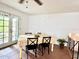 Dining room with a table with a tablecloth, black wooden chairs, and a view through glass doors at 370 S Center St, Ormond Beach, FL 32174