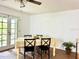 Dining room area with white walls, tile flooring, glass doors, and a wooden table with chairs at 370 S Center St, Ormond Beach, FL 32174