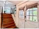 Inviting entryway featuring wood stairs leading to a split-level home with natural light at 370 S Center St, Ormond Beach, FL 32174