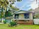 Charming home with a stone foundation, front balcony, and well-maintained landscaping at 370 S Center St, Ormond Beach, FL 32174