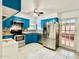 The kitchen features stainless steel appliances and bright blue cabinets at 370 S Center St, Ormond Beach, FL 32174