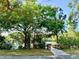 Scenic lake view with a wooden bridge, surrounded by lush landscaping and trees at 370 S Center St, Ormond Beach, FL 32174