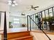 Cozy living area with hardwood floors, wrought iron railing, ceiling fans, and neutral-colored walls at 370 S Center St, Ormond Beach, FL 32174