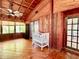 Open living area with wood ceiling and paneling, a white crib, and lots of natural light at 370 S Center St, Ormond Beach, FL 32174