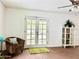 Cozy living room with earth-tone decor, tile flooring, and glass doors leading to the exterior at 370 S Center St, Ormond Beach, FL 32174