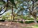 Community playground featuring colorful equipment, surrounded by mature trees and landscaping at 370 S Center St, Ormond Beach, FL 32174