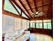 Bright sun room with a white couch, wood ceiling, blinds, multiple windows, and a ceiling fan at 370 S Center St, Ormond Beach, FL 32174