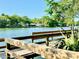 Scenic view of a serene lake from a wooden dock surrounded by lush green trees and greenery at 370 S Center St, Ormond Beach, FL 32174