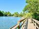 Scenic view of a serene lake from a wooden dock surrounded by lush green trees and greenery at 370 S Center St, Ormond Beach, FL 32174