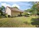 View of the home's backyard, showcasing the lawn, landscaping, and exterior elevation at 405 Secluded Oaks Trl, Deland, FL 32724