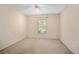 Bedroom featuring light walls and carpet with a window and ceiling fan at 405 Secluded Oaks Trl, Deland, FL 32724