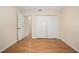 Bedroom featuring wood-look floors and a closet; open door leads to an adjoining room at 405 Secluded Oaks Trl, Deland, FL 32724