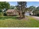 Beautiful brick home with an attached garage, neat landscaping, and a well-maintained lawn at 405 Secluded Oaks Trl, Deland, FL 32724