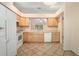 Functional kitchen with tile flooring, ample counter space, and white appliances at 405 Secluded Oaks Trl, Deland, FL 32724