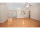 Living room featuring hardwood floors, a ceiling fan, and access to multiple rooms at 405 Secluded Oaks Trl, Deland, FL 32724