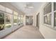 Bright sunroom with carpeting, lots of windows with natural light, and a ceiling fan at 405 Secluded Oaks Trl, Deland, FL 32724