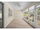 Bright sunroom featuring carpeting, multiple windows providing natural light, and a ceiling fan at 405 Secluded Oaks Trl, Deland, FL 32724