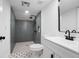 Modern bathroom featuring a tiled shower, white vanity, and patterned tile floors at 415 W Church St, Deland, FL 32720