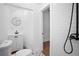 Bright bathroom featuring white subway tile shower and contemporary vanity with black fixtures at 415 W Church St, Deland, FL 32720